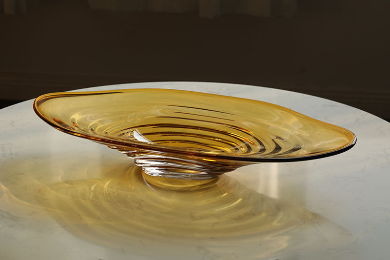 An amber glass decorative bowl